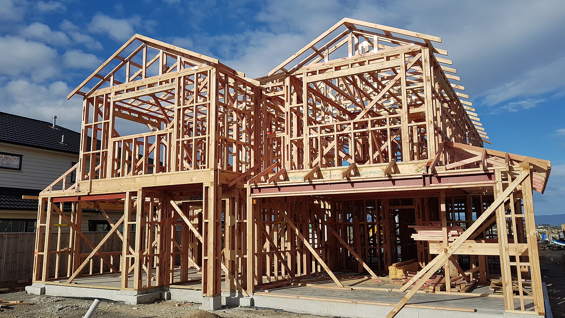 A two-storey timber house frame on a new concrete slab